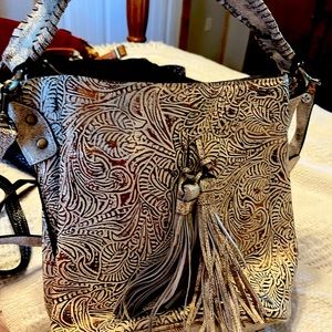 Bucket style purse with hand or shoulder strap. cream with brown/ gold accent